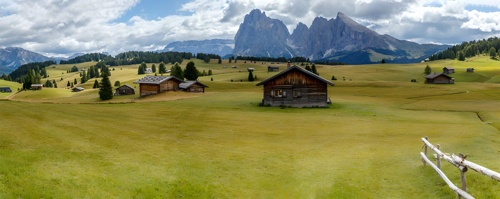 TPES93464: Cabañas en una pradera entre montañas