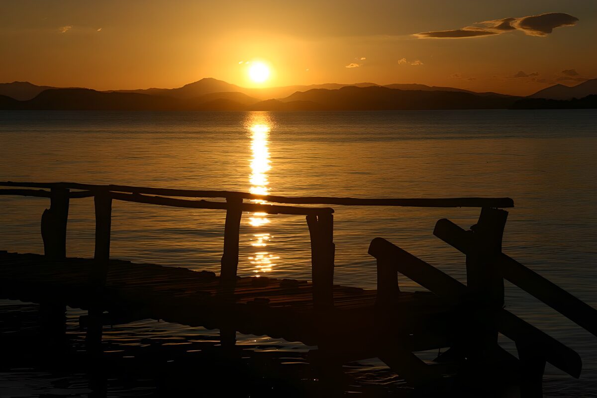 Atardecer sobre el agua y el muelle