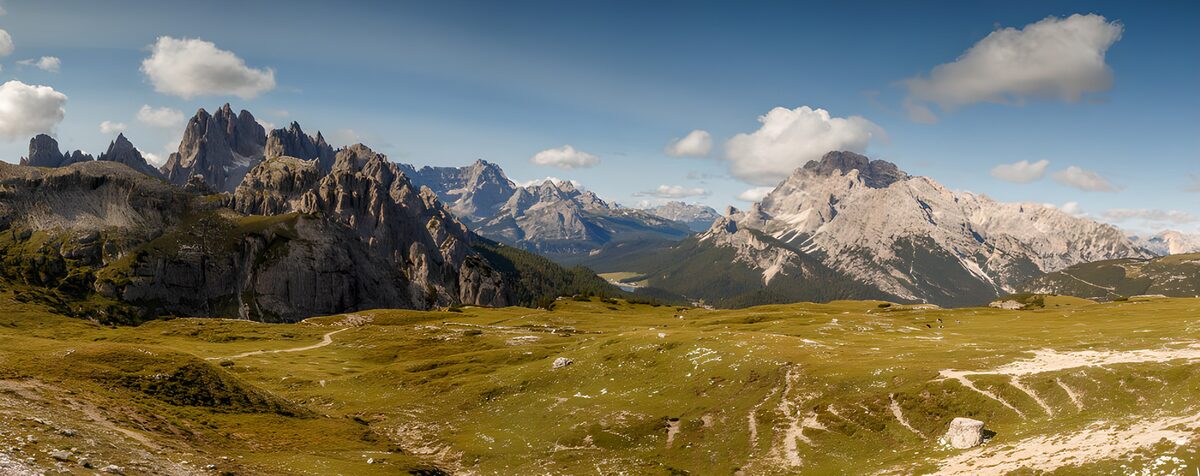 Pradera y cumbres bajo el cielo azul