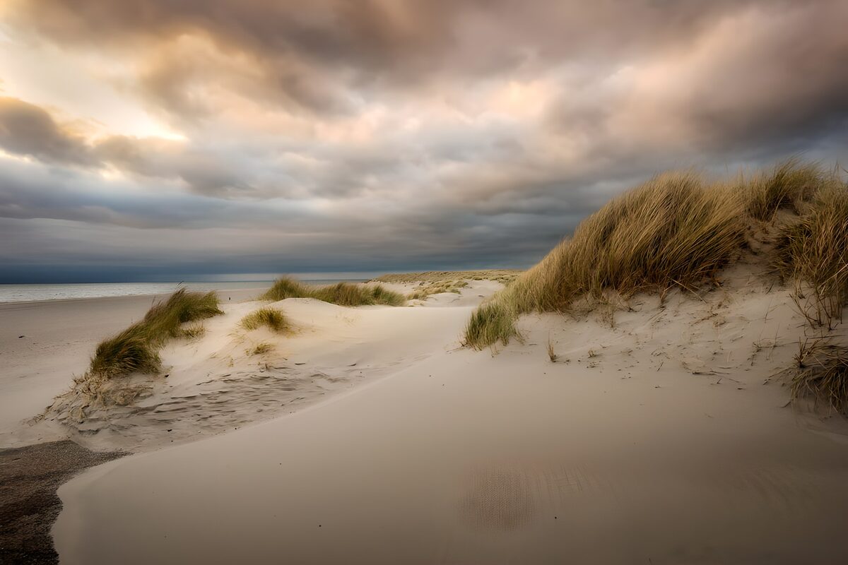 Dunas y mar bajo un cielo de tormenta